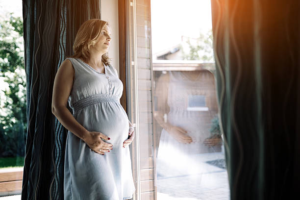 istock Pregnant woman holding her belly 541130702