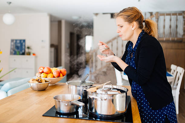 istock Housewife tasting food being made in kitchen 541132208