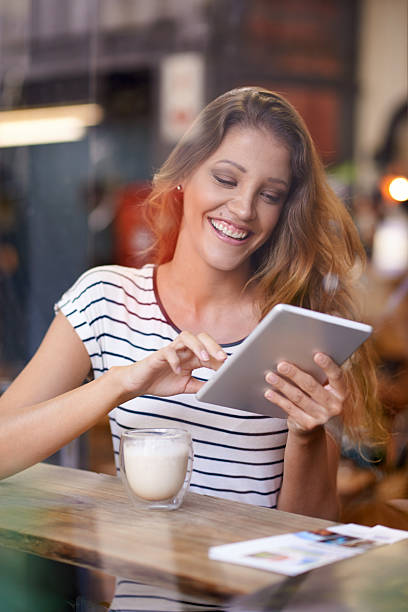istock Sharing her coffee house experiences with her online friends 541133458