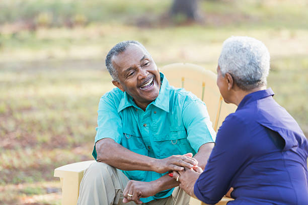 istock Senior African American couple sitting outdoors laughing 541133572