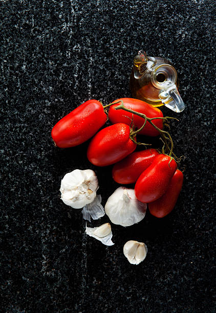 istock ingredients on a black marble: ripe tomatoes, olive oil 541133818