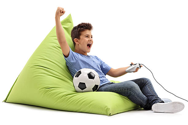istock Joyful kid playing football video game 541134056