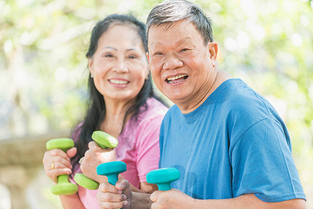 istock Senior Asian couple exercising outdoors, focus on man 541134464