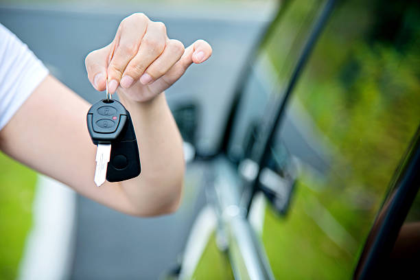 istock Woman hand holding new car key 541134620