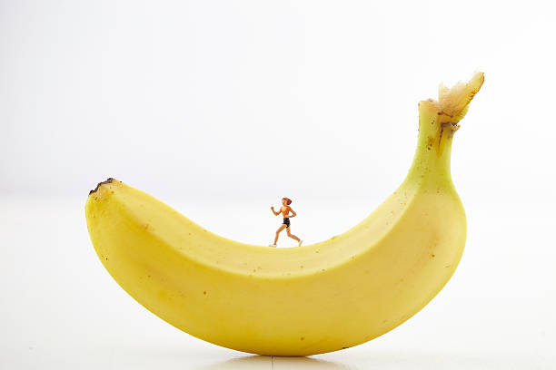 Jogging miniature woman on banana