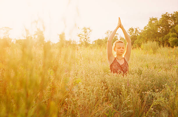 istock Woman doing yoga in grass. 541135564