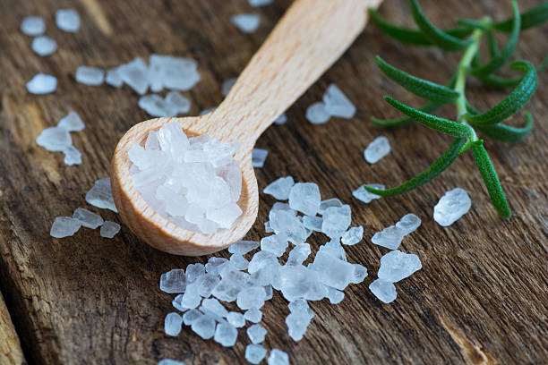 Closeup of salt on wooden table stock photo