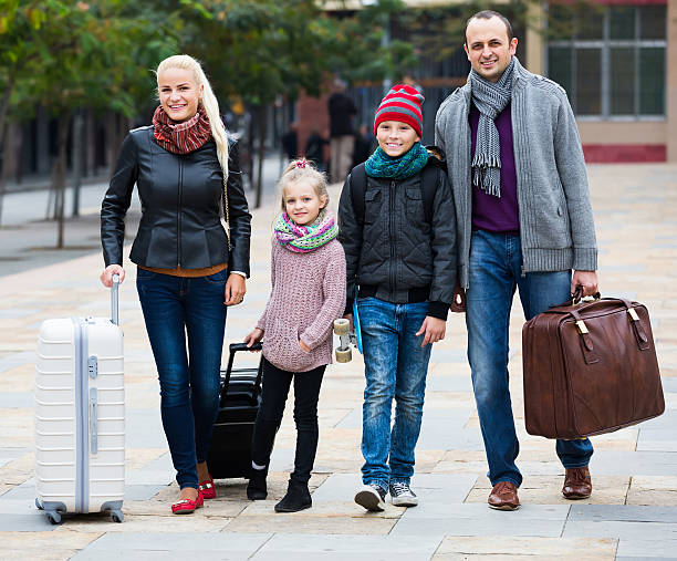 istock Family journey: spouses with children walking and luggage 541136004