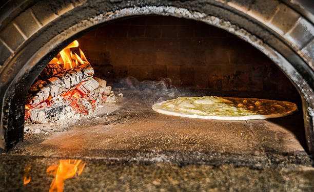 istock pizza dough in traditional wood fired stove 541143898