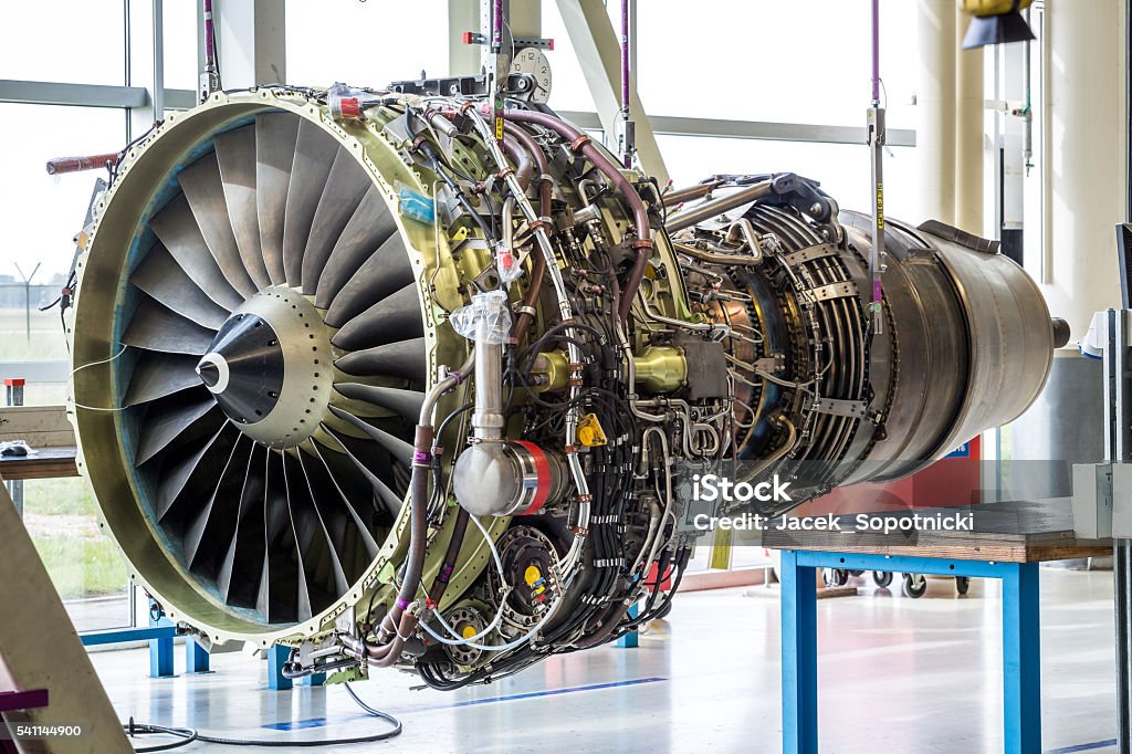 Engine's maintenance in huge industrial hall Engine's maintenance in huge industrial hall . Airplane Stock Photo