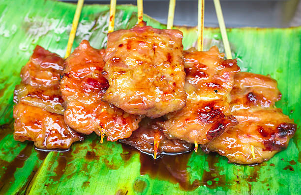 istock Place the pork on banana leaf green 541146478