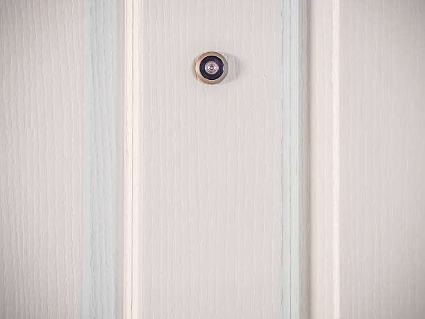 Door lens peephole security on wooden texture stock photo