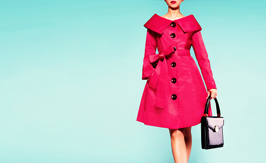 Red coat woman with black leather handbag. Beautiful vintage style.