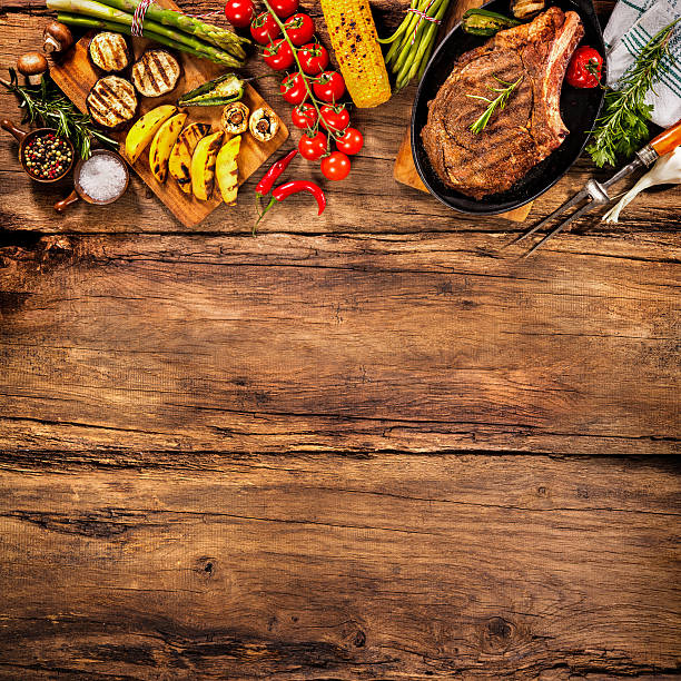 istock Beef steak with grilled vegetables on wood 541150248
