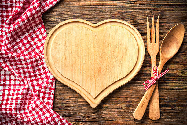 istock Heart shaped cutting board with a red checkered tablecloth 541151198