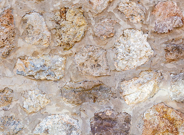 Ancient roughness stone wall. A lot of different stones stock photo