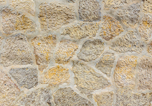 Ancient roughness stone wall. Stonework of sandstone. stock photo