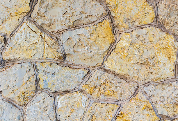 Old stone wall. Stonework of sandstone. Golden and grey texture stock photo