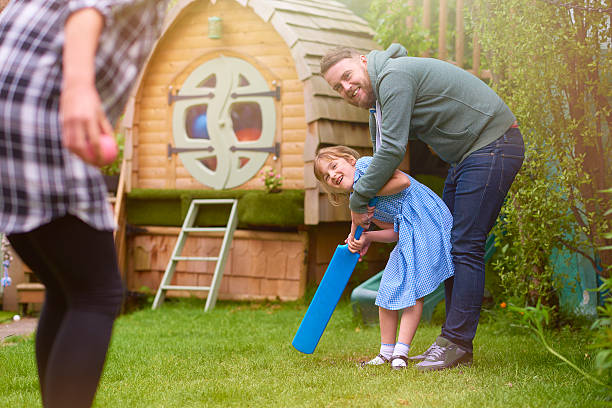 istock father and daughter's cricket game 541153378