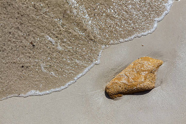 istock The sand under the water. A lone Golden stone. 541153758