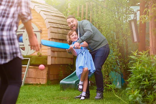 istock father and daughter playing cricket 541153762