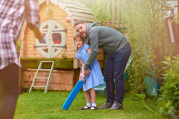istock father and daughter playing cricket 541153980