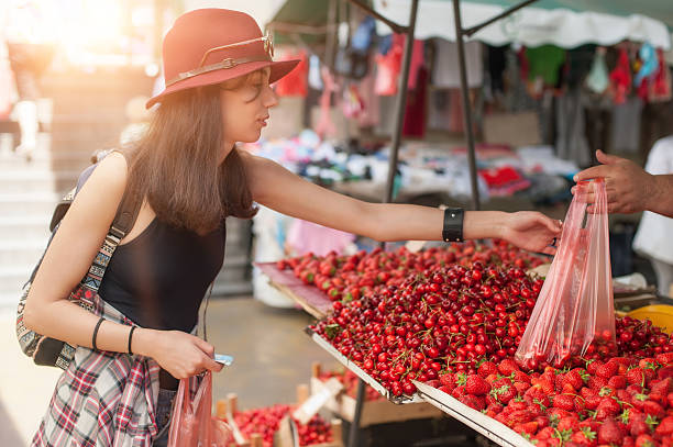 woman at the fruit and vegetable market - market fruit strawberry farmers market imagens e fotografias de stock