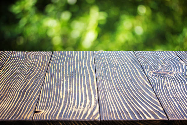 istock Wooden deck table over beautiful bokeh background 541155138