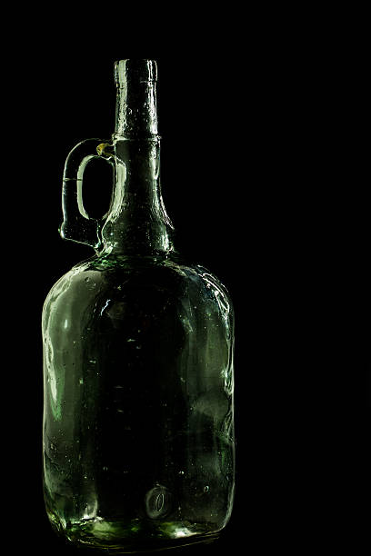 istock glass bottle, empty, original, on black background 541155560