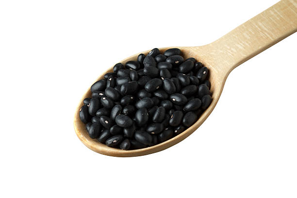istock Black beans in a wooden spoon 541156054