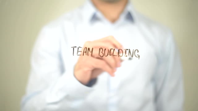 Team Building, Man Writing on Transparent Screen