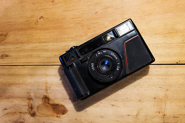 istock Old Vintage camera on wooden background 541265428
