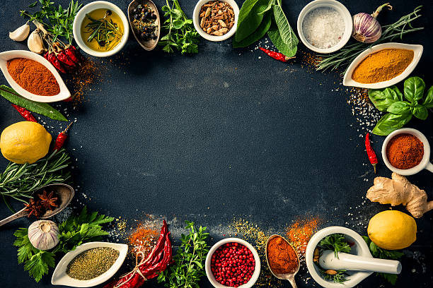 istock Herbs and spices over black stone background 541265768