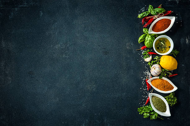 istock Herbs and spices over black stone background 541265888