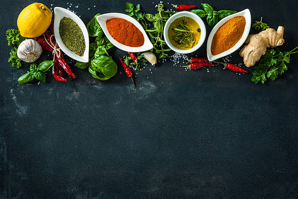 istock Herbs and spices over black stone background 541265986