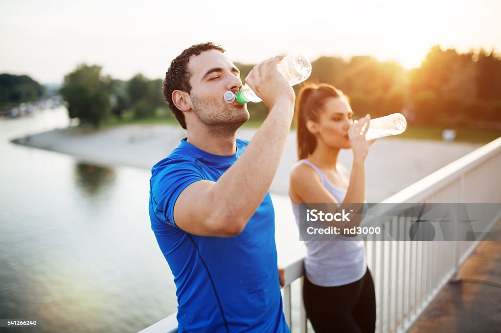 Couple staying hydrated Couple staying hydrated after workout Drinking Stock Photo