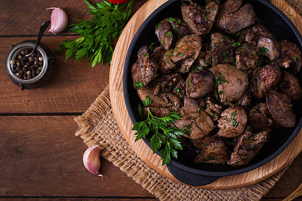 Fried chicken liver with onions and herbs stock photo