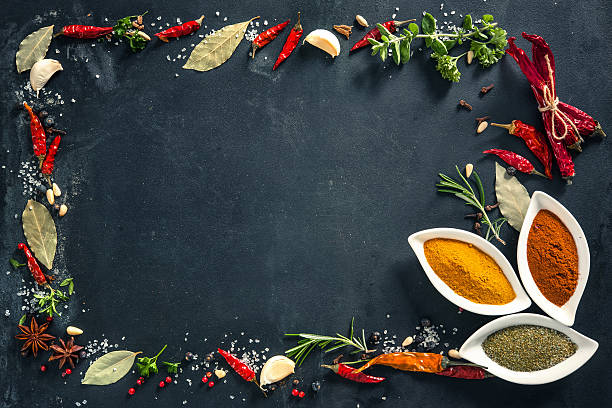 istock Herbs and spices over black stone background 541266530
