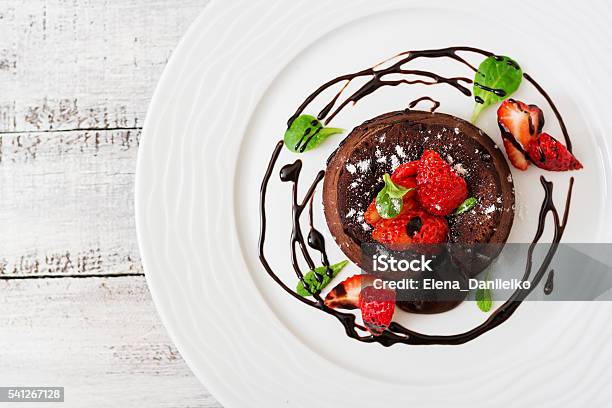 Chocolate Fondant With Strawberries And Powdered Sugar Top View Stock Photo - Download Image Now