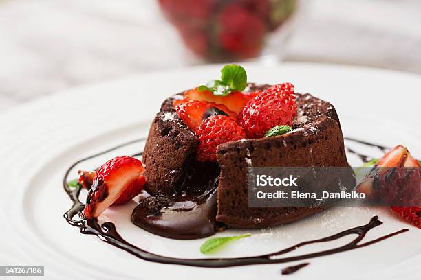 Chocolate Fondant With Strawberries And Powdered Sugar Stock Photo - Download Image Now