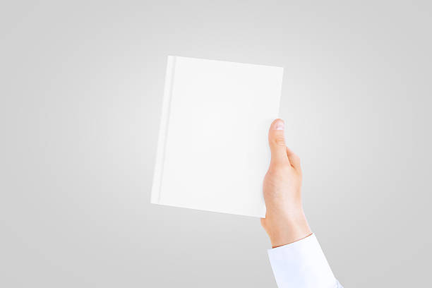 istock Hand in white shirt sleeve holding closed blank book. 541267246