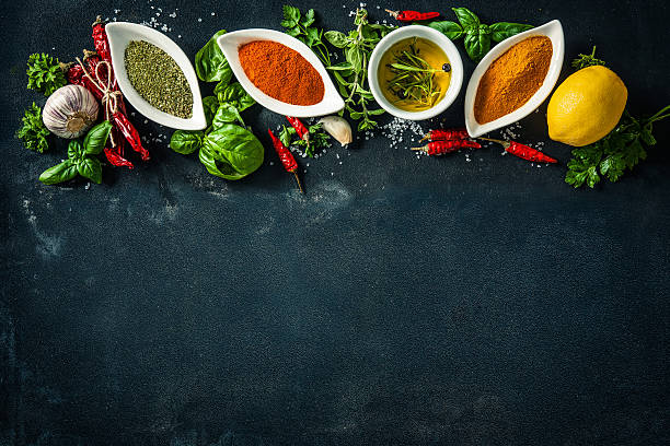 istock Herbs and spices over black stone background 541268046