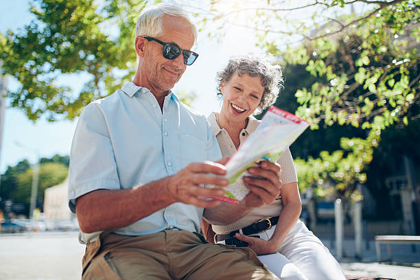 istock Mature couple sitting outdoors with a city map 541268402