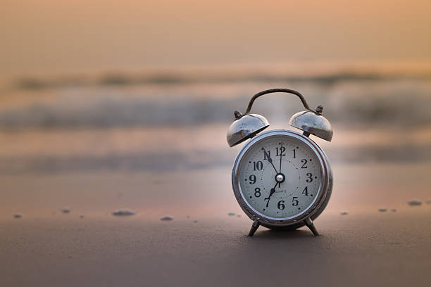 istock Concept alarm clock on beach still life Retro 541268458