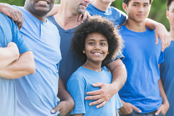 istock Mixed race African American boy with group of men 541268484