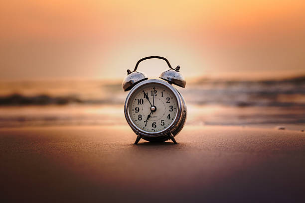 istock Concept alarm clock on beach still life Retro 541268638