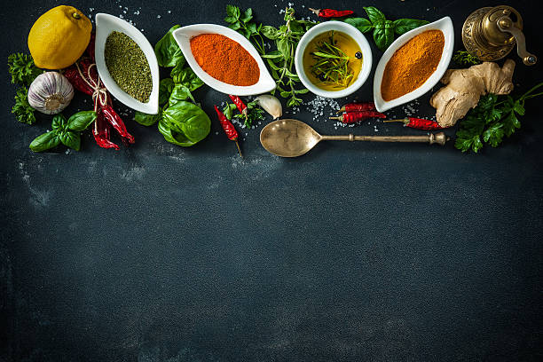 istock Herbs and spices over black stone background 541268964