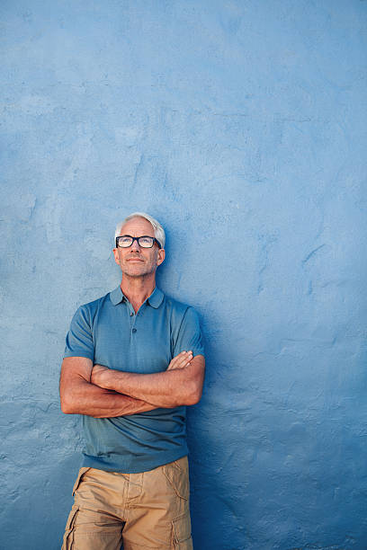 istock Confident mature man looking up at copy space 541269328