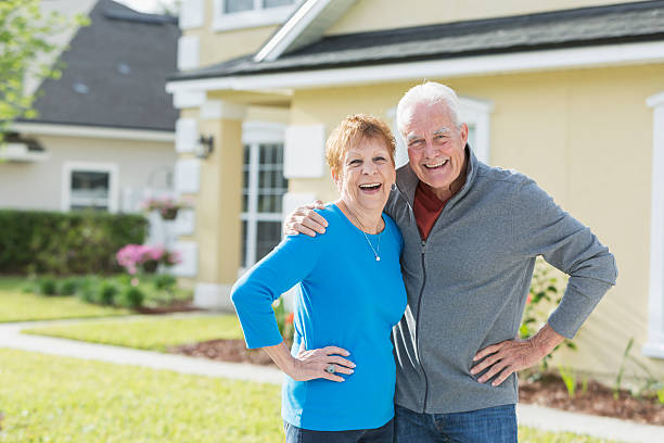 istock Senior couple standing together outside house 541269966