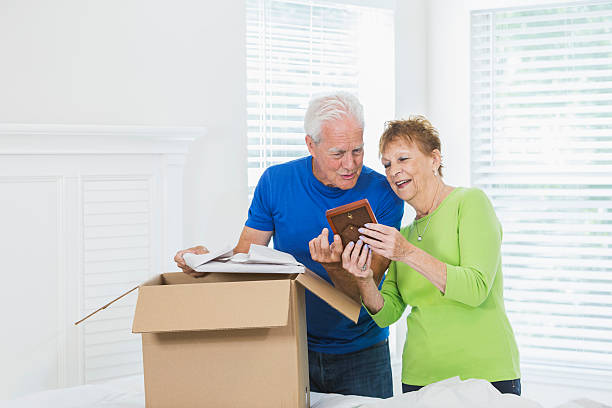 istock Senior couple moving house, packing box 541270052